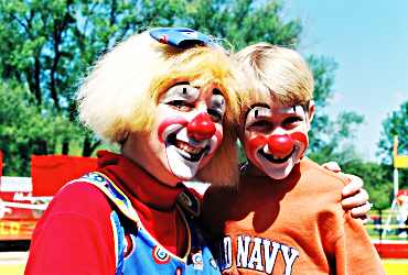 At Circus World, a clown poses with a boy.