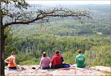 A family of hikers enjoys the view from Carlton Peak.
