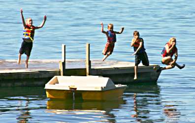 Kids jump off the raft at a Minnesota lake resort.