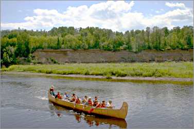A voyageur canoe makes a loop from Fort William.