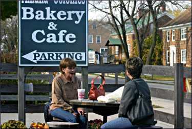 Women have a bite at the Amana bakery.