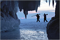 Photographers leave the ice caves at dusk.