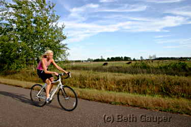 A bicyclist pedals on the Old Abe State Trail.