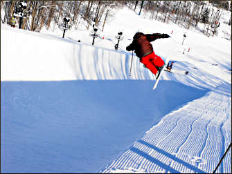 A snowboarder on a superpipe.