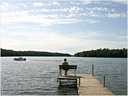 Sitting on a dock at a lake resort.