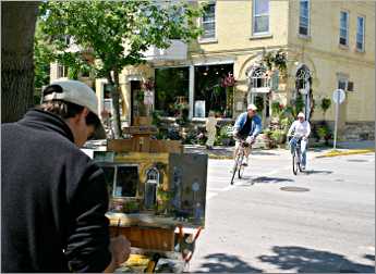 A painter works on Cedarburg's shopping street.