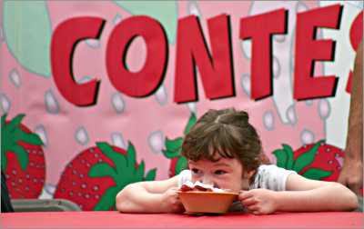 A girl gobbles strawberry shortcake in Cedarburg