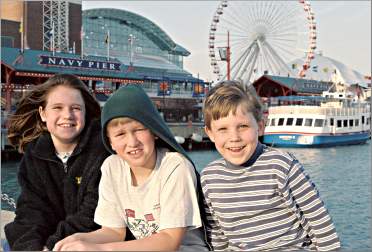 Children pose by Navy Pier in Chicago.