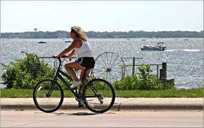 A bicyclist rides along the shore of Clear Lake.