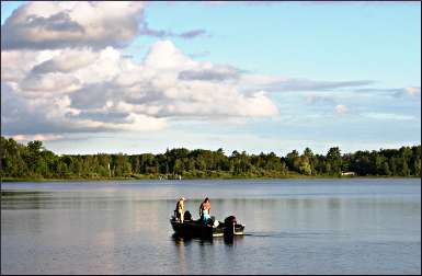 Fishing from a boat in a lake.