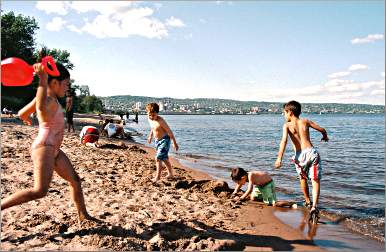 Kids play on the Park Point beach.