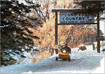 Snowmobiles roar toward Eagle River.