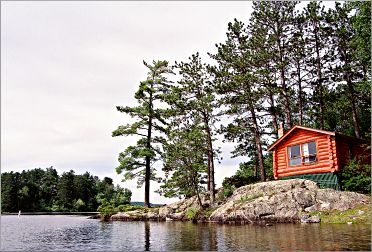 A burnt-orange cabin at Ely's Burntside Resort is frequently