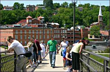 In Galena, tourists watch a canoe race.