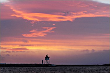 A lighthouse at sunset.