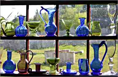 Old-style bottles glow in the window at Grand Portage.