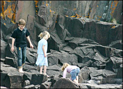 Kids play on the rocks in Grand Marais.