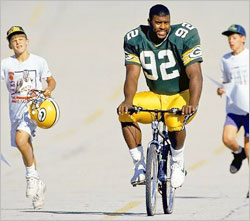 
At the Packers' camp, kids bring bikes for players to ride to practice.
