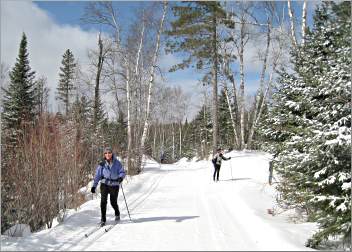 Skiers glide on trails along the Gunflint's Flour Lake.