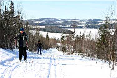 Skiers climb a hill above Gunflint Lake.