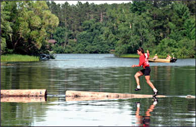 A lumberjack on a boom run.