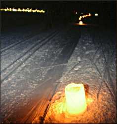 Luminaries line a ski trail.