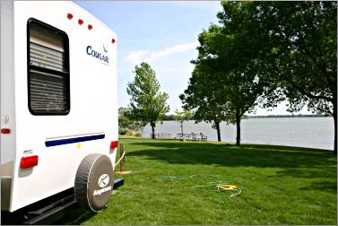 A camper sits by a Kandiyohi County lake.