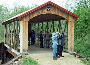 Birders on a covered bridge.