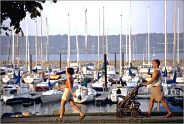 People stroll by Lake City marina.