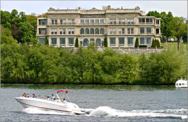 A speedboat cruises past Lake Geneva's Stone Manor.