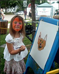 A child paints at Lake Mills Arts Festival.