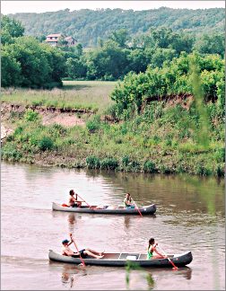 Canoeists paddle the Root River near Lanesboro.