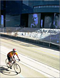 A bicyclist rides by the Guthrie Theater.