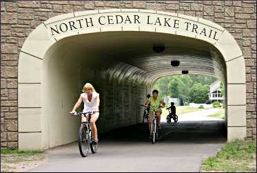 A bicyclist on the North Cedar Lake Trail.