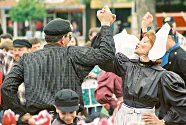 Costumed folk dancers twirl during Tulip Time in Pella, Iowa