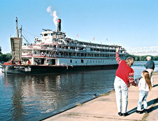 People wave as the Mississippi Queen leaves Red Wing.
