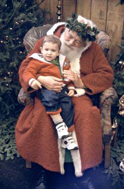 Father Christmas with child on his lap.