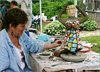 At Shake Rag Alley, Tonie Rocke finishes a garden sculpture.