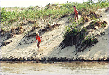 Girls run into the Platte River.