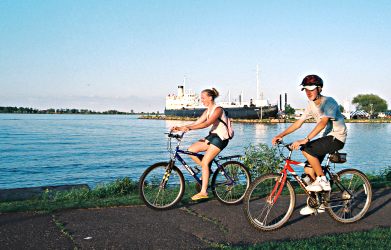 Bicyclists pass the S.S. Meteor on Superior's Osaugie Trail.