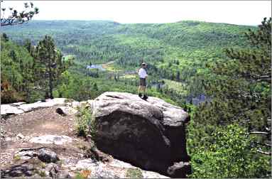 A hiker enjoys the view from Mount Trudee on the Superior Hi