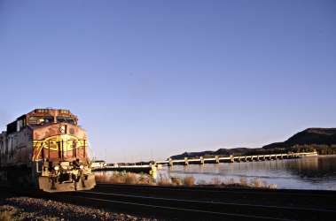 A train runs along river in Trempealeau.