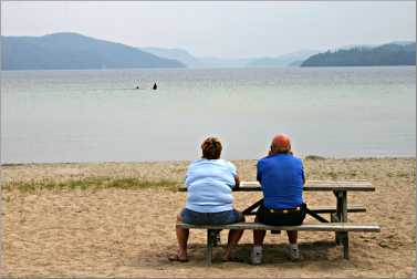 couple sit looking at beach in Wawa, ont.